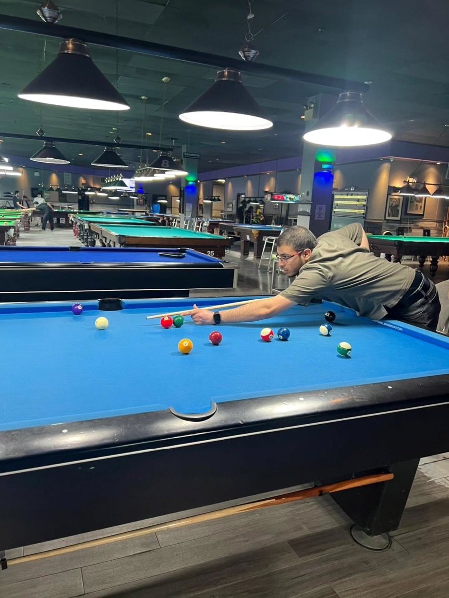 Mustafa taking a pool shot